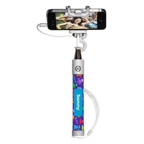 Personalized selfie stick personalized with monsters pattern and name in caribbean blue
