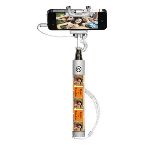 Personalized selfie stick personalized with a photo and the saying "I Love You Brandon!" in black and juicy orange