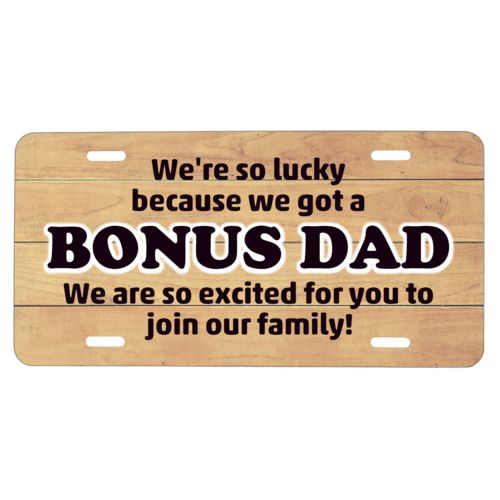 Custom car plate personalized with natural wood pattern and the sayings "We're so lucky because we got a We are so excited for you to join our family!" and "BONUS DAD"