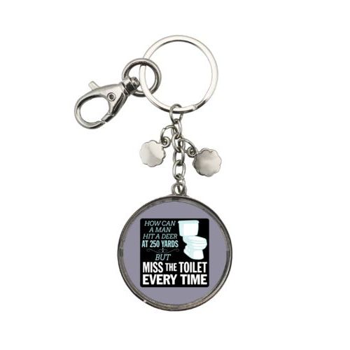Personalized keychain personalized with the saying "How can a man hit a deer at 250 yards but keeps missing the toilet"