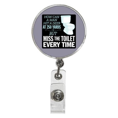 Personalized badge reel personalized with the saying "How can a man hit a deer at 250 yards but keeps missing the toilet"
