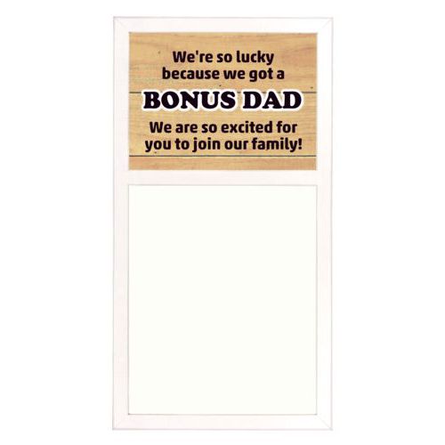 Personalized white board personalized with natural wood pattern and the sayings "We're so lucky because we got a We are so excited for you to join our family!" and "BONUS DAD"