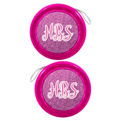 Personalized yoyo personalized with light pink glitter pattern and the saying "HBS"