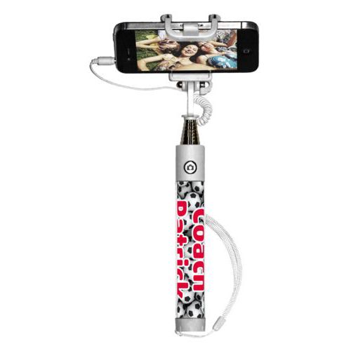 Personalized selfie stick personalized with soccer balls pattern and the saying "Coach Patrick"