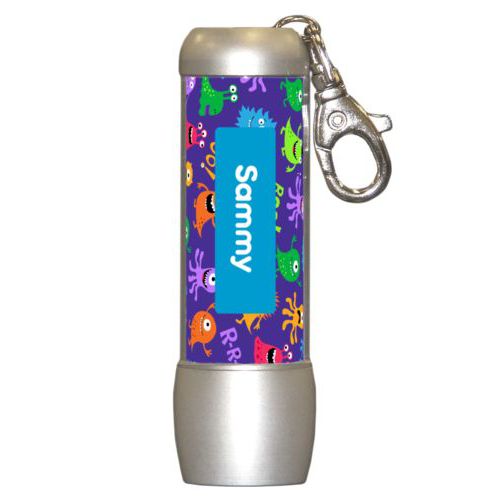 Personalized flashlight personalized with monsters pattern and name in caribbean blue