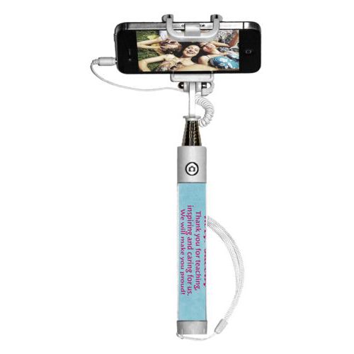 Personalized selfie stick personalized with teal chalk pattern and the saying "Mrs. Jacobs Thank you for teaching, inspiring and caring for us. We will make you proud! With love from, Your 4th Grade Class"