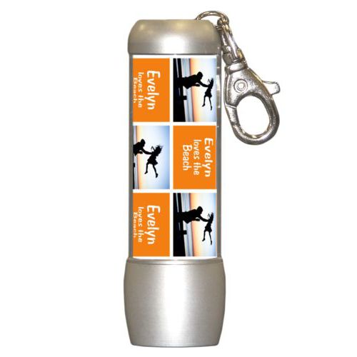 Personalized flashlight personalized with a photo and the saying "Evelyn loves the Beach" in juicy orange and white