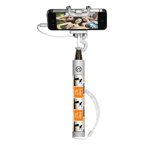 Personalized selfie stick personalized with a photo and the saying "Evelyn loves the Beach" in juicy orange and white