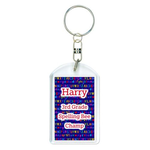Personalized plastic keychain personalized with alphabet pattern and the saying "Harry 3rd Grade Spelling Bee Champ"