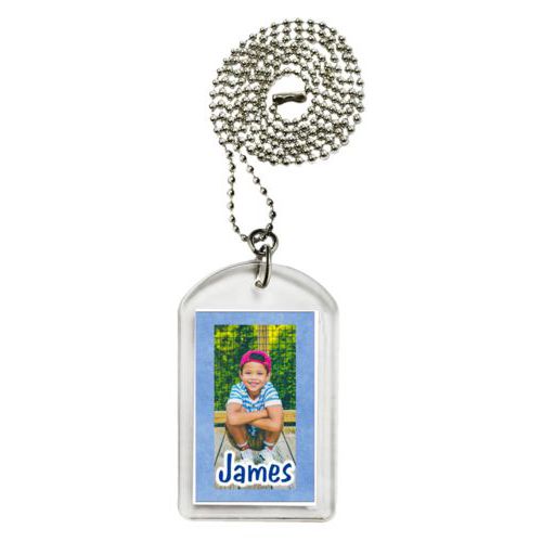 Personalized dog tag personalized with blue chalk pattern and photo and the saying "James"