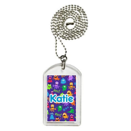 Personalized dog tag personalized with monsters pattern and the saying "Katie"