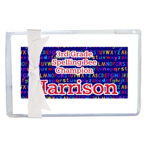 Personalized enclosure cards personalized with alphabet pattern and the saying "3rd Grade Spelling Bee Champion Harrison"