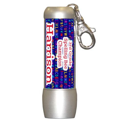 Personalized flashlight personalized with alphabet pattern and the saying "3rd Grade Spelling Bee Champion Harrison"