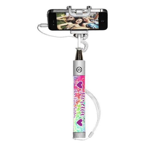 Personalized selfie stick personalized with glitter pattern and the sayings "Amelia the Big Sister" and "Heart" and "Heart"