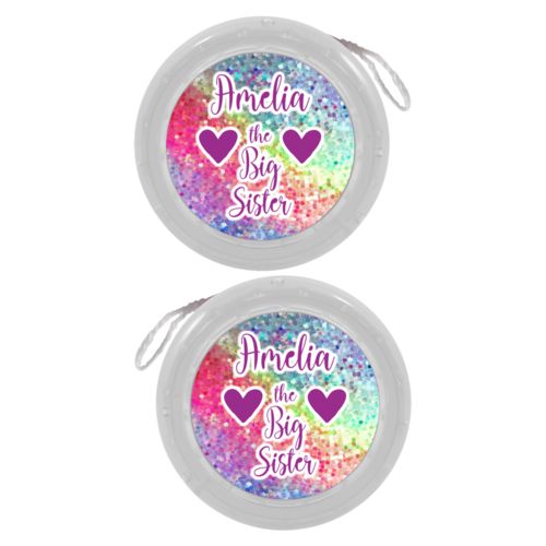 Personalized yoyo personalized with glitter pattern and the sayings "Amelia the Big Sister" and "Heart" and "Heart"