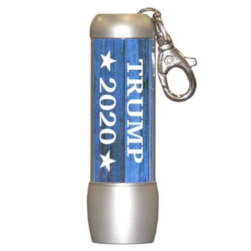 Small bright personalized flasklight personalized with "Trump 2020" on blue wood grain design