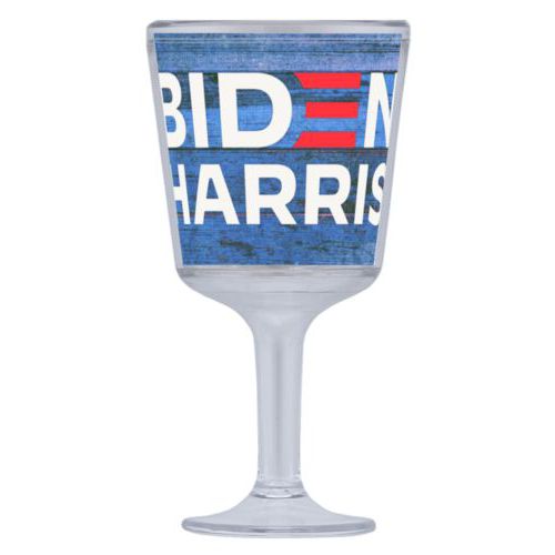 Plastic wine glass personalized with "Biden Harris" logo on blue wood design